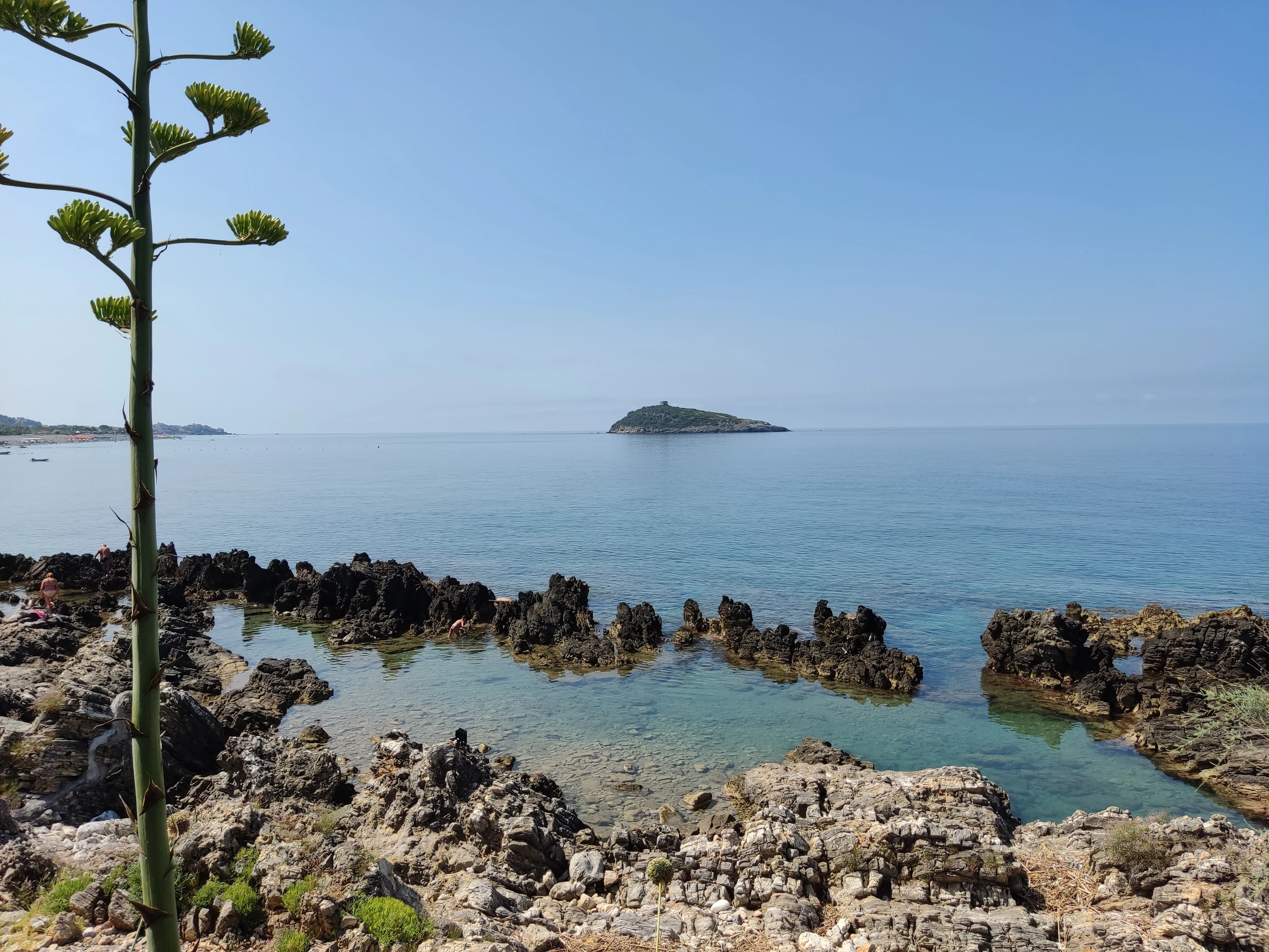 Rocce della scogliera di Cirella, acqua trasparente e Isola di Cirella all'orizzonte